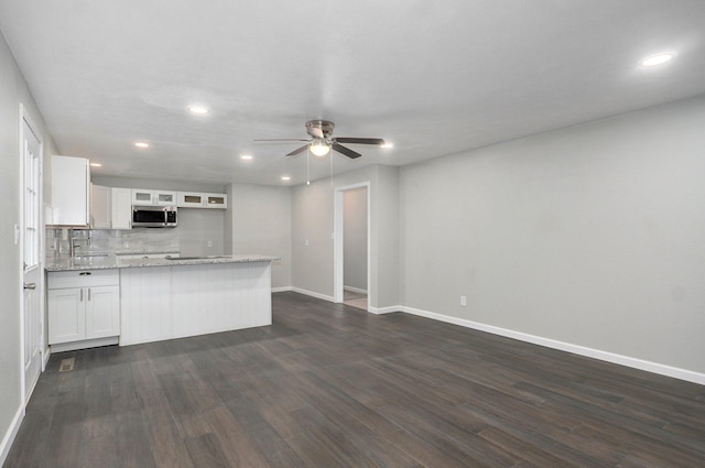 4852 S Fremont Ave, Springfield, MO 65804 - kitchen with stainless steel microwave, ceiling fan, white cabinetry, recessed lighting, and dark wood-style flooring