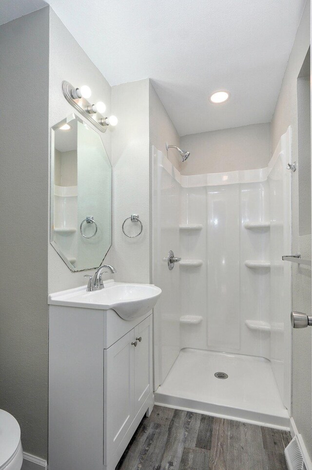 4852 S Fremont Ave, Springfield, MO 65804 - bathroom with wood finished floors, vanity, and a shower