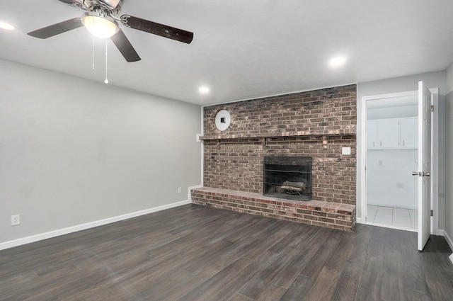 4852 S Fremont Ave, Springfield, MO 65804 - unfurnished living room with wood finished floors, a ceiling fan, recessed lighting, and a fireplace