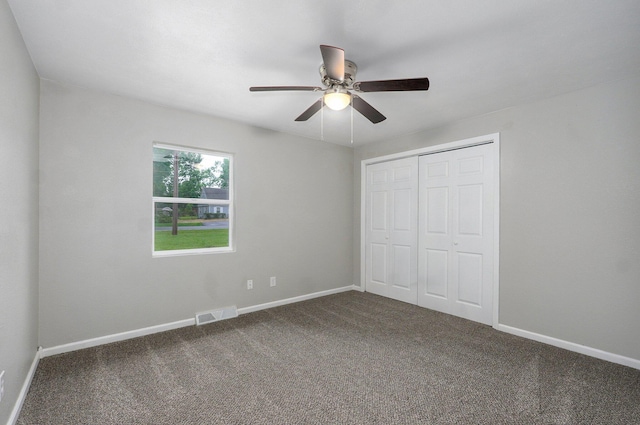 4852 S Fremont Ave, Springfield, MO 65804 - unfurnished bedroom featuring dark colored carpet, a closet, and a ceiling fan