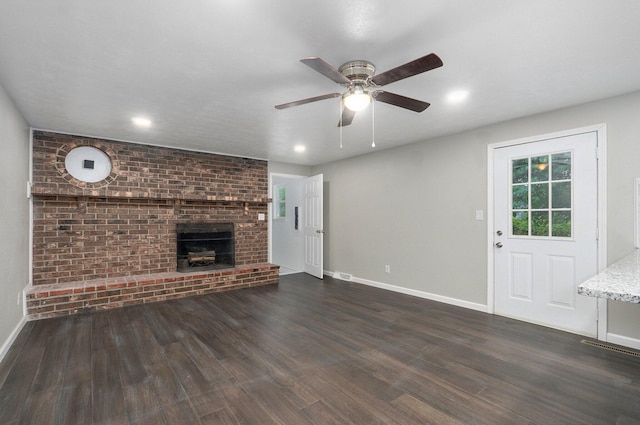 4852 S Fremont Ave, Springfield, MO 65804 - unfurnished living room featuring a ceiling fan, dark wood-style flooring, a fireplace, and recessed lighting