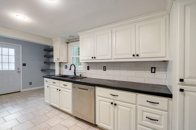 902 S Hickory St, Mount Vernon, MO 65712 - kitchen with dishwasher, dark countertops, decorative backsplash, light tile patterned floors, and white cabinets