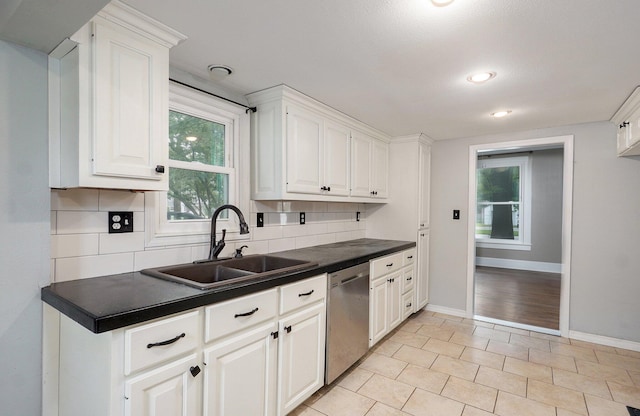 902 S Hickory St, Mount Vernon, MO 65712 - kitchen featuring dishwasher, tasteful backsplash, dark countertops, and plenty of natural light