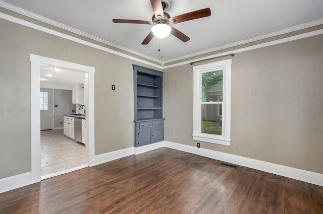 902 S Hickory St, Mount Vernon, MO 65712 - empty room featuring crown molding, a ceiling fan, dark wood finished floors, and built in shelves