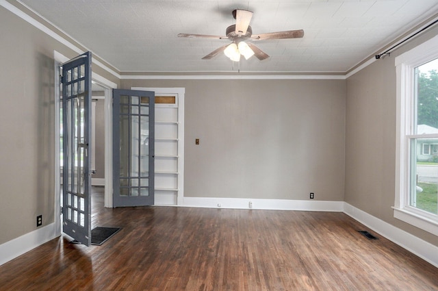 902 S Hickory St, Mount Vernon, MO 65712 - spare room featuring crown molding, wood finished floors, healthy amount of natural light, ceiling fan, and french doors