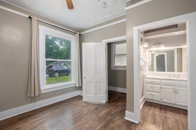 902 S Hickory St, Mount Vernon, MO 65712 - unfurnished bedroom featuring crown molding, dark wood-style floors, and ensuite bathroom