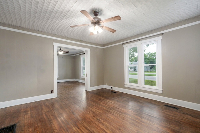 902 S Hickory St, Mount Vernon, MO 65712 - spare room featuring a ceiling fan, ornamental molding, and dark wood-type flooring