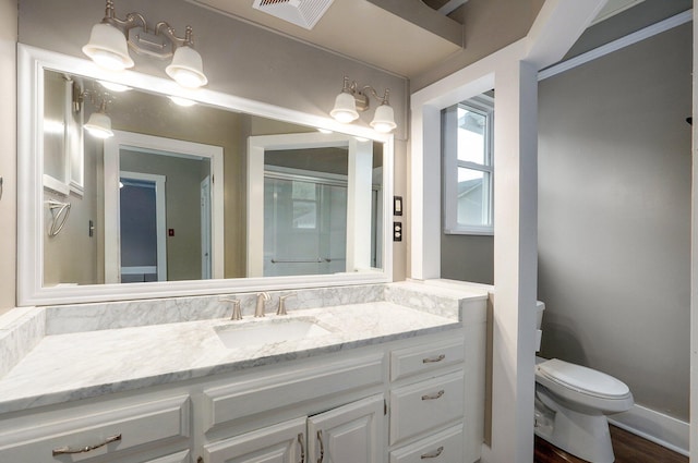902 S Hickory St, Mount Vernon, MO 65712 - full bathroom featuring vanity, wood finished floors, and a shower with shower door