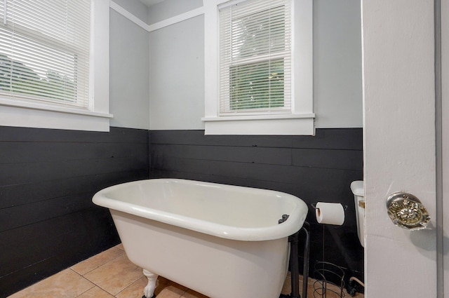 902 S Hickory St, Mount Vernon, MO 65712 - full bathroom with a wainscoted wall, a soaking tub, tile patterned floors, and wooden walls