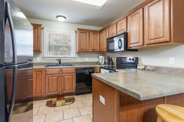 2529 State Highway 176 Unit F2, Rockaway Beach, MO 65740 - kitchen featuring black appliances, a peninsula, brown cabinets, and a breakfast bar