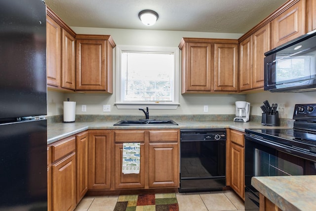 2529 State Highway 176 Unit F2, Rockaway Beach, MO 65740 - kitchen featuring black appliances, brown cabinetry, light tile patterned floors, and a textured ceiling