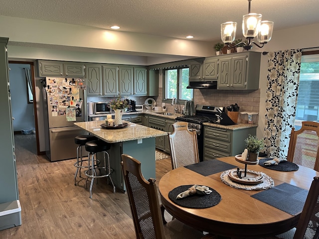 508 E Kirkwood Dr, Aurora, MO 65605 - kitchen with stainless steel appliances, light wood-style flooring, decorative backsplash, a textured ceiling, and recessed lighting