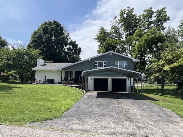 508 E Kirkwood Dr, Aurora, MO 65605 - view of front of home featuring driveway, a chimney, and a carport