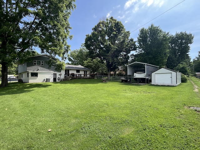 508 E Kirkwood Dr, Aurora, MO 65605 - view of green lawn with a carport and a storage shed
