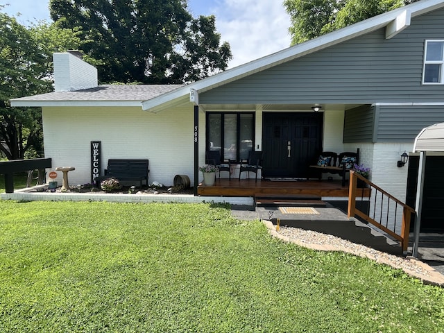 508 E Kirkwood Dr, Aurora, MO 65605 - back of house with brick siding, a lawn, a chimney, and covered porch