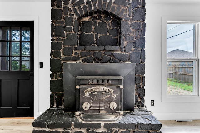 2564 S Regina Ave, Springfield, MO 65807 - detailed view of wood finished floors and a fireplace with raised hearth