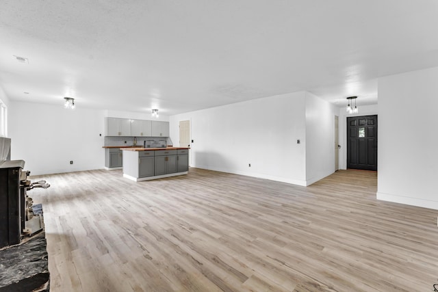 2564 S Regina Ave, Springfield, MO 65807 - unfurnished living room featuring light wood finished floors and baseboards
