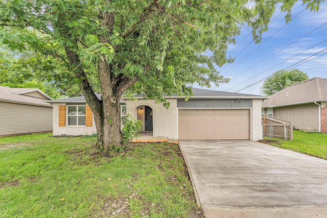 2564 S Regina Ave, Springfield, MO 65807 - view of front of house with brick siding, an attached garage, and driveway