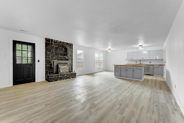 2564 S Regina Ave, Springfield, MO 65807 - unfurnished living room with light wood-style flooring and healthy amount of natural light