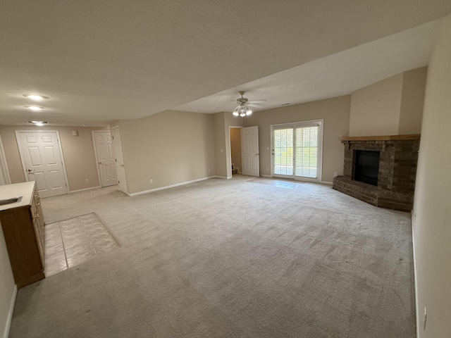 5218 S Gary Ct, Springfield, MO 65810 - unfurnished living room with a ceiling fan, light carpet, and a brick fireplace