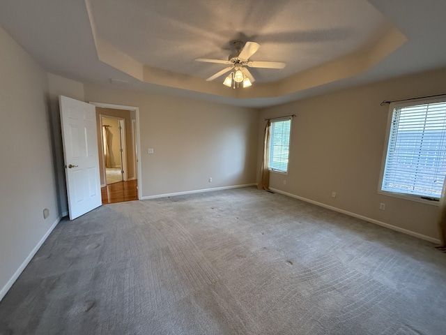 5218 S Gary Ct, Springfield, MO 65810 - carpeted empty room featuring a tray ceiling and a ceiling fan