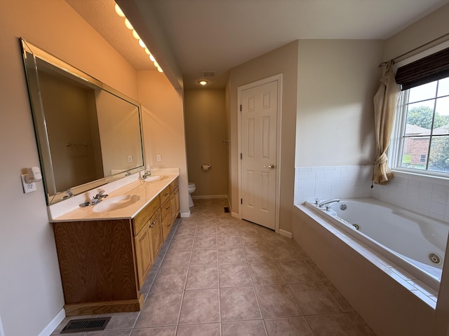 5218 S Gary Ct, Springfield, MO 65810 - bathroom featuring double vanity, a jetted tub, and tile patterned flooring