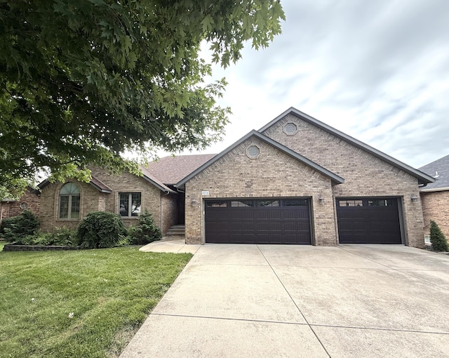 5218 S Gary Ct, Springfield, MO 65810 - view of front of home featuring an attached garage, concrete driveway, a front yard, and brick siding