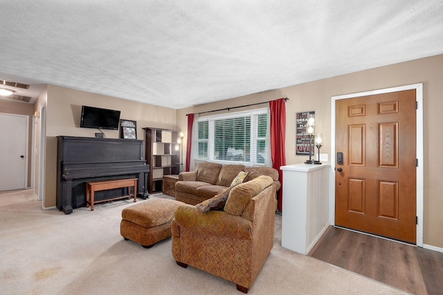 3449 N Rogers Ave, Springfield, MO 65803 - carpeted living area featuring a textured ceiling and baseboards