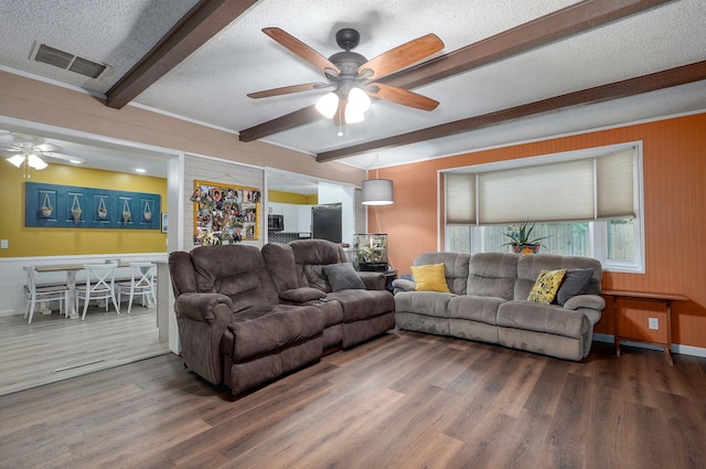 3449 N Rogers Ave, Springfield, MO 65803 - living area with beamed ceiling, a ceiling fan, wood finished floors, a textured ceiling, and wood walls
