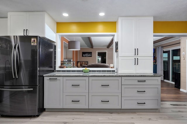 3449 N Rogers Ave, Springfield, MO 65803 - kitchen with freestanding refrigerator, white cabinets, light wood-style floors, beam ceiling, and recessed lighting
