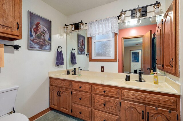 3449 N Rogers Ave, Springfield, MO 65803 - bathroom featuring toilet and double vanity