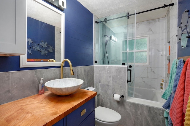 3449 N Rogers Ave, Springfield, MO 65803 - full bath featuring tile walls, a shower stall, vanity, and a textured ceiling