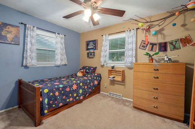 3449 N Rogers Ave, Springfield, MO 65803 - carpeted bedroom with multiple windows and ceiling fan