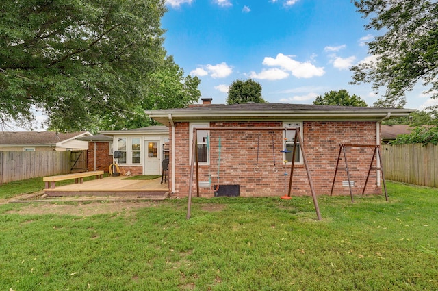 3449 N Rogers Ave, Springfield, MO 65803 - rear view of house with a deck, a chimney, and brick siding
