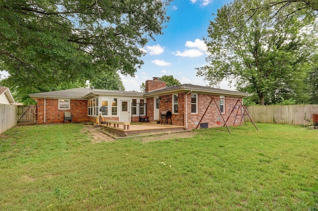 3449 N Rogers Ave, Springfield, MO 65803 - rear view of house featuring a chimney, a fenced backyard, brick siding, and a wooden deck