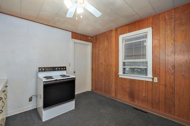 408 S 8th Ave, Ozark, MO 65721 - kitchen with white electric stove, wood walls, dark colored carpet, and ceiling fan