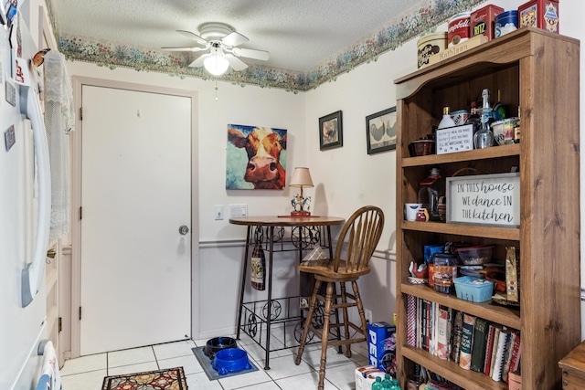 781 Santana Cir, Reeds Spring, MO 65737 - tiled dining area with ceiling fan and a textured ceiling