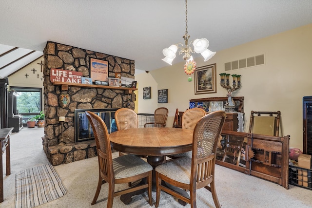 781 Santana Cir, Reeds Spring, MO 65737 - carpeted dining area with a chandelier and a stone fireplace