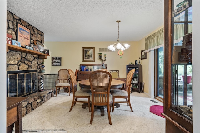 781 Santana Cir, Reeds Spring, MO 65737 - carpeted dining space featuring a textured ceiling, a chandelier, and a fireplace
