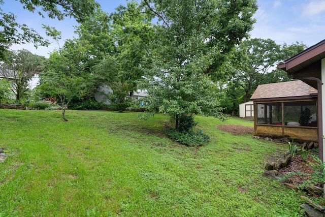 781 Santana Cir, Reeds Spring, MO 65737 - view of green lawn featuring a sunroom and a storage unit