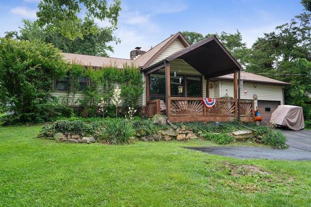 781 Santana Cir, Reeds Spring, MO 65737 - ranch-style house with a chimney, a front lawn, an attached garage, a wooden deck, and asphalt driveway