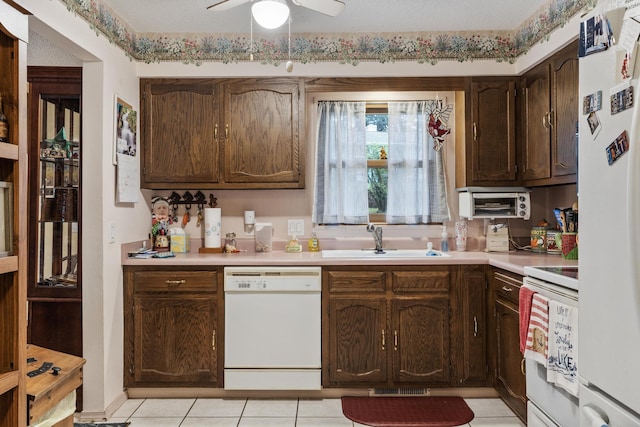 781 Santana Cir, Reeds Spring, MO 65737 - kitchen with white appliances, light countertops, light tile patterned floors, a ceiling fan, and dark brown cabinetry