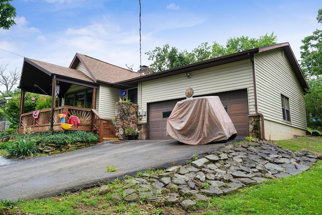 781 Santana Cir, Reeds Spring, MO 65737 - view of front of house featuring an attached garage, asphalt driveway, and roof with shingles