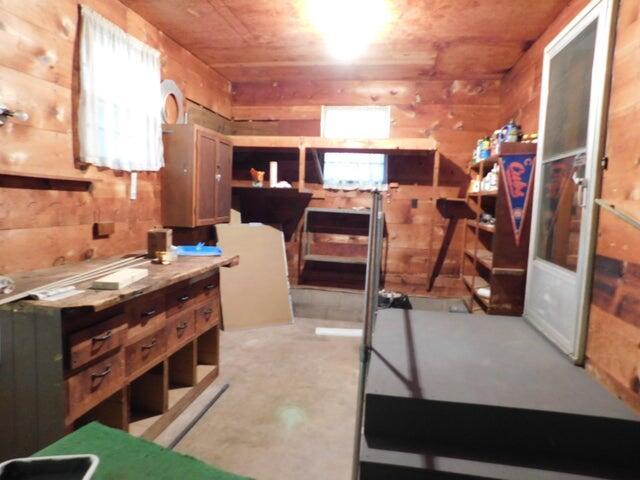1128 E Crest Dr, Houston, MO 65483 - bedroom featuring wooden walls and concrete flooring