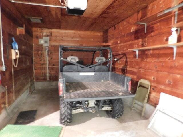 1128 E Crest Dr, Houston, MO 65483 - bedroom with wood walls and concrete flooring