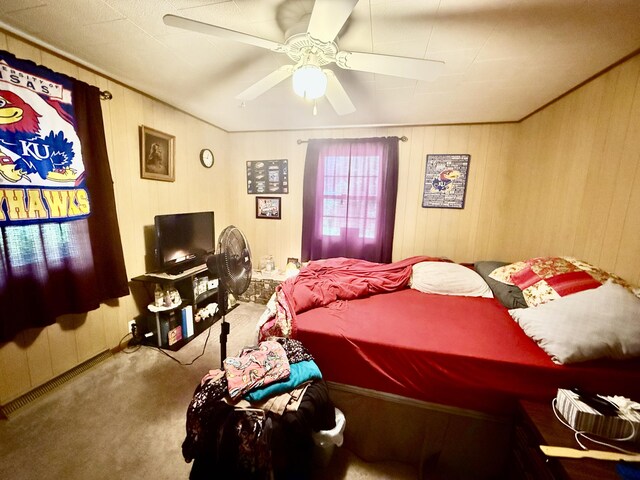 1128 E Crest Dr, Houston, MO 65483 - carpeted bedroom featuring ceiling fan and wood walls