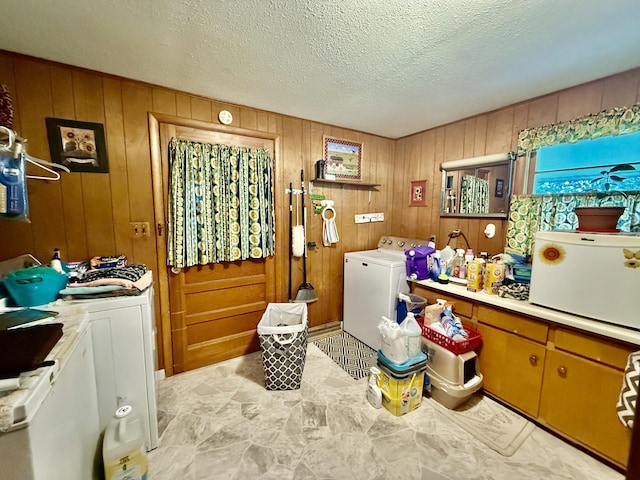 1128 E Crest Dr, Houston, MO 65483 - laundry area with washing machine and clothes dryer, wooden walls, and a textured ceiling