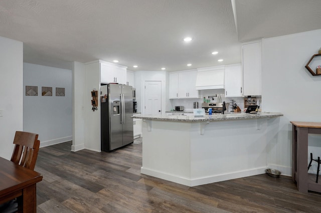 1611 E Hayloft Dr, Ozark, MO 65721 - kitchen with stainless steel appliances, a peninsula, dark wood-style floors, light stone countertops, and recessed lighting