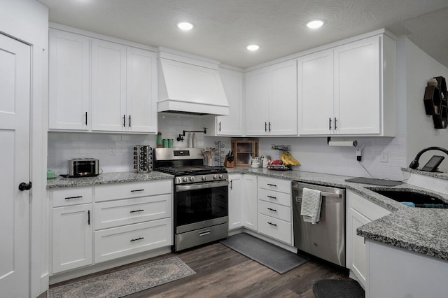 1611 E Hayloft Dr, Ozark, MO 65721 - kitchen featuring stainless steel appliances, premium range hood, white cabinetry, dark wood-type flooring, and tasteful backsplash