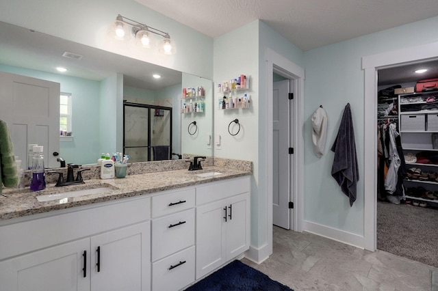 1611 E Hayloft Dr, Ozark, MO 65721 - bathroom featuring a stall shower, double vanity, and a spacious closet